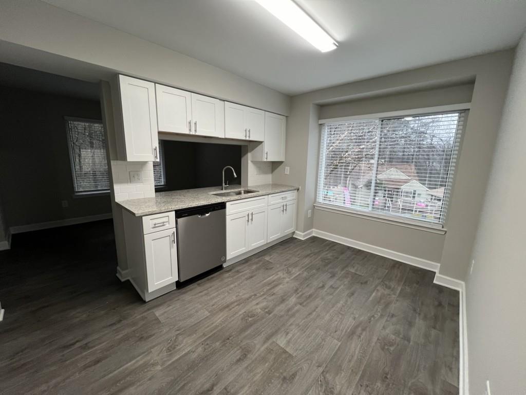 1035 Seasons Parkway Norcross, GA 30093 - Photo 12 of 22 a kitchen with stainless steel appliances a stove top oven a sink and a microwave