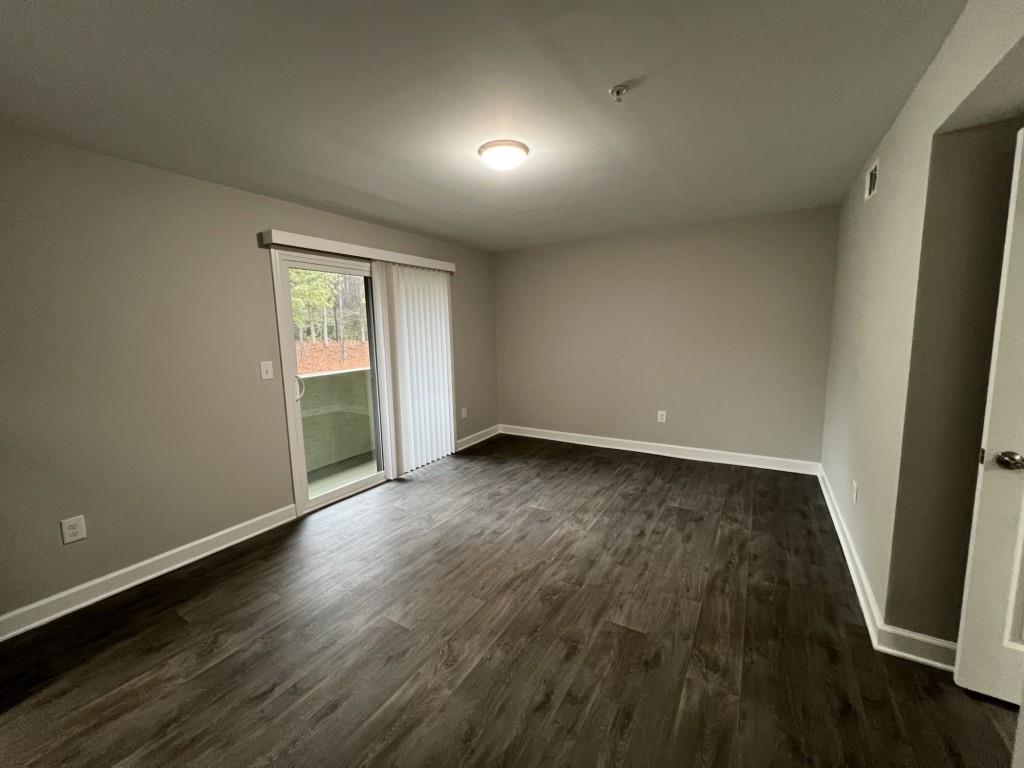 1035 Seasons Parkway Norcross, GA 30093 - Photo 13 of 22 an empty room with wooden floor and windows