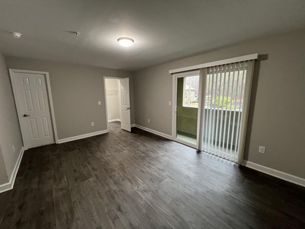 1035 Seasons Parkway Norcross, GA 30093 - Photo 14 of 22 an empty room with wooden floor and windows