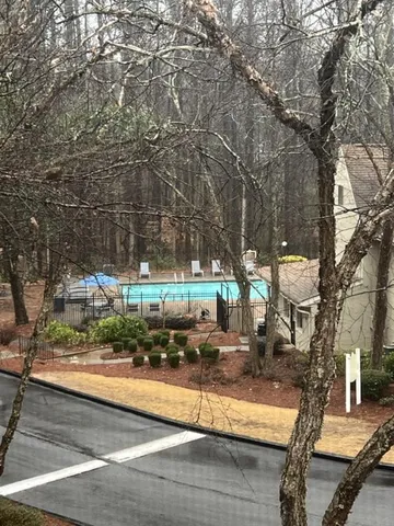 a view of a yard with large trees