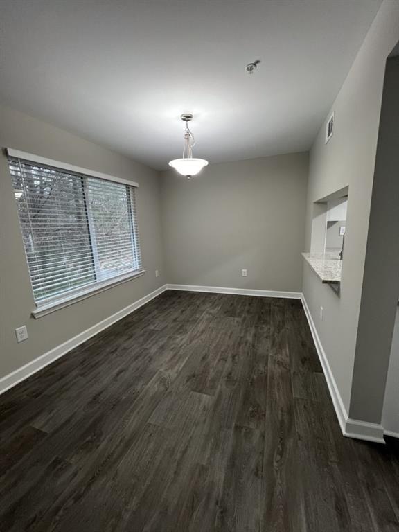 1035 Seasons Parkway Norcross, GA 30093 - Photo 4 of 22 an empty room with wooden floor and windows