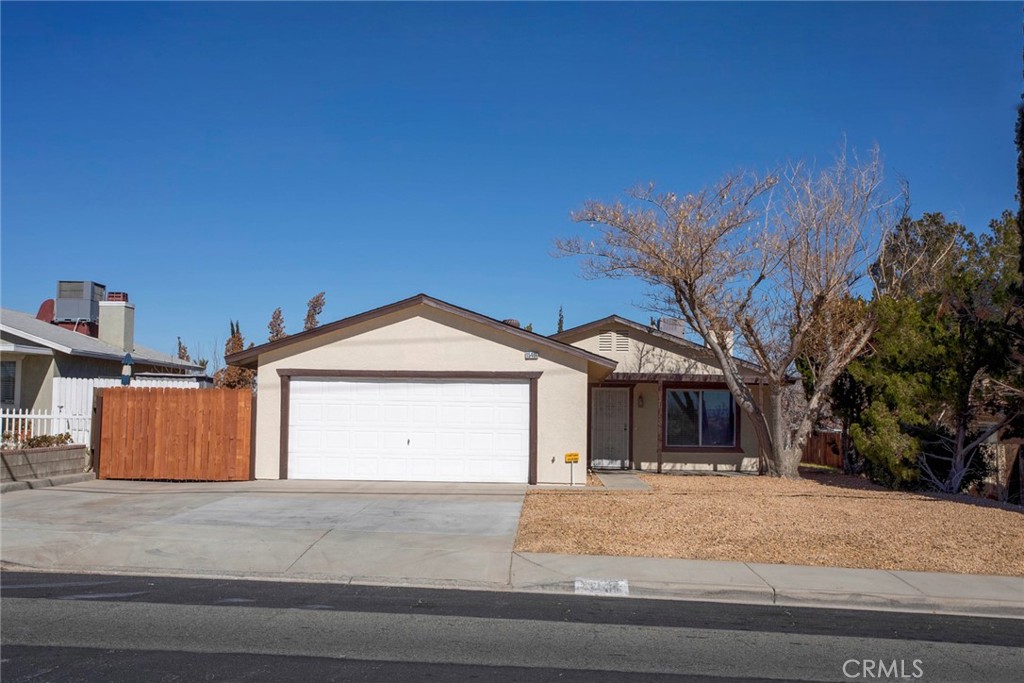 a view of a house with a yard and garage
