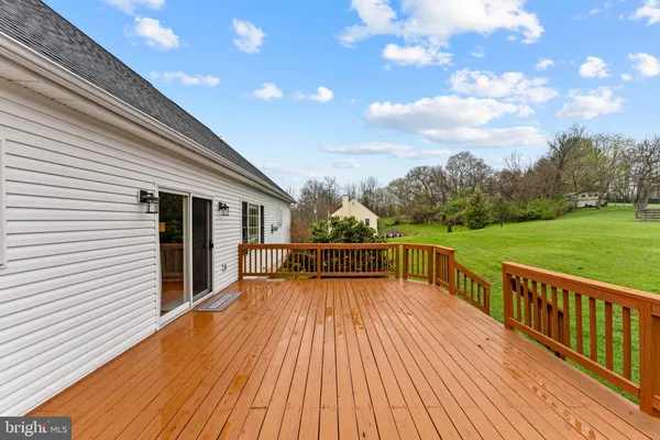 a view of a house with a wooden deck