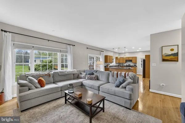 a kitchen with stainless steel appliances granite countertop a sink a stove and a wooden cabinets