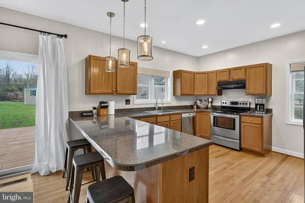 a large kitchen with a sink and cabinets