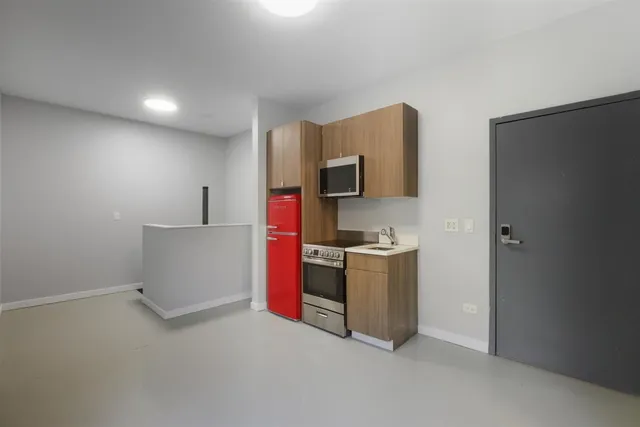 a kitchen with stainless steel appliances a refrigerator and a stove top oven