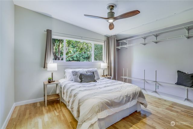 a bedroom with a bed and a large window