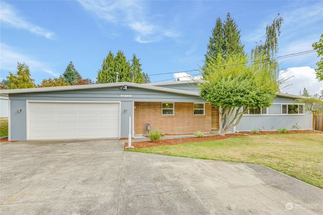 a view of a house with a yard and garage