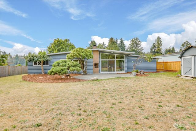 a view of a house with a backyard and a garden