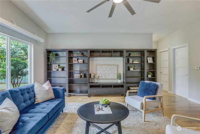 a living room with furniture and a wooden floor