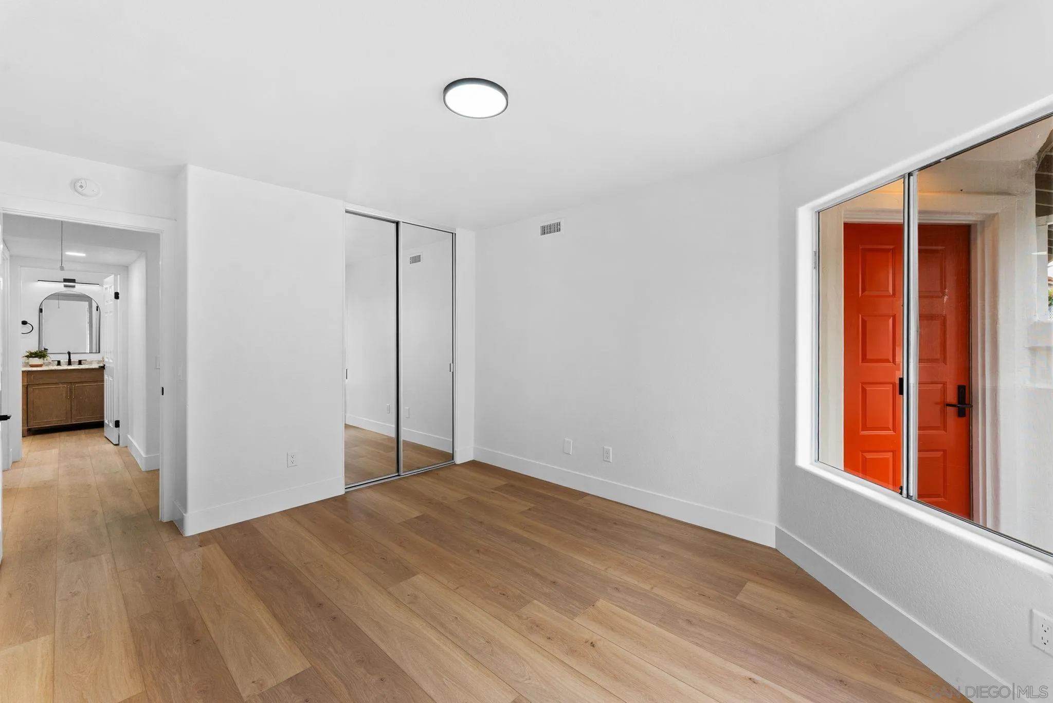 4695 Adra Way Oceanside, CA 92056 - Photo 23 of 29 wooden floor in an empty room with a window