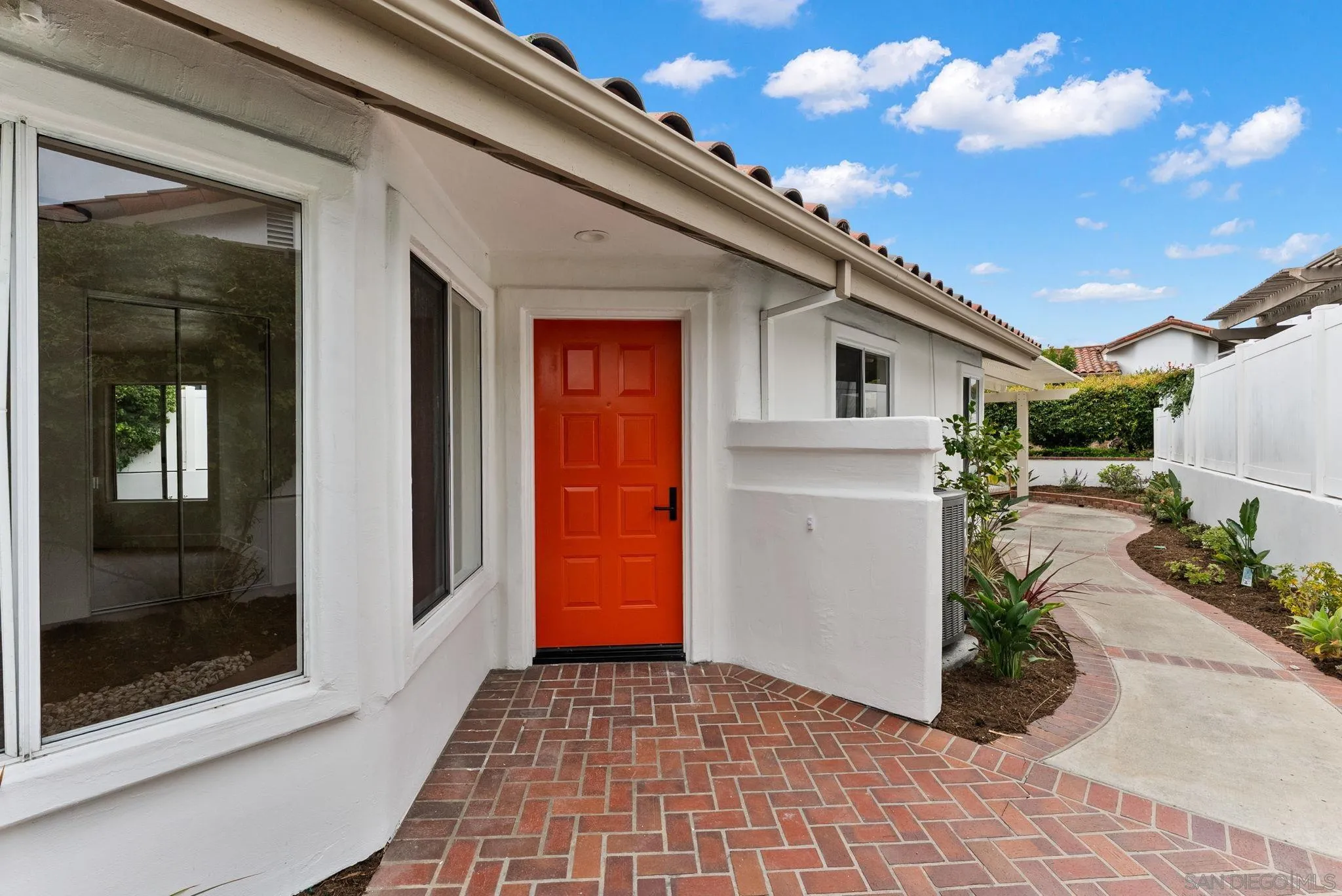 4695 Adra Way Oceanside, CA 92056 - Photo 8 of 29 a view of a house with a large windows and plants