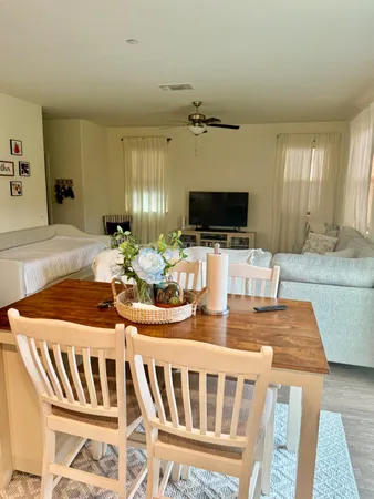a kitchen with a stove and a dining table