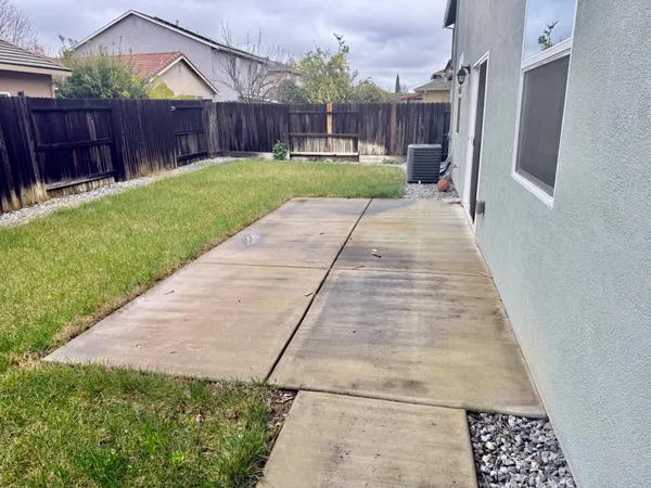 a view of a backyard with wooden fence