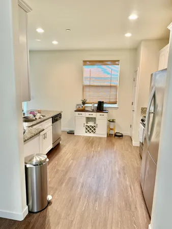 a kitchen with stainless steel appliances a stove a refrigerator and wooden cabinets