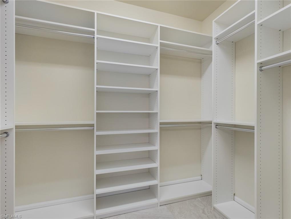 19953 Beverly Park Road Estero, FL 33928 - Photo 16 of 35 a view of walk in closet with empty racks