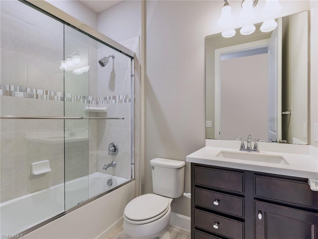 19953 Beverly Park Road Estero, FL 33928 - Photo 18 of 35 a bathroom with a sink a toilet and shower