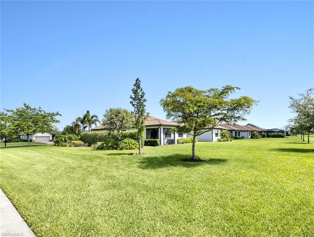 19953 Beverly Park Road Estero, FL 33928 - Photo 23 of 35 a house with garden in front of it