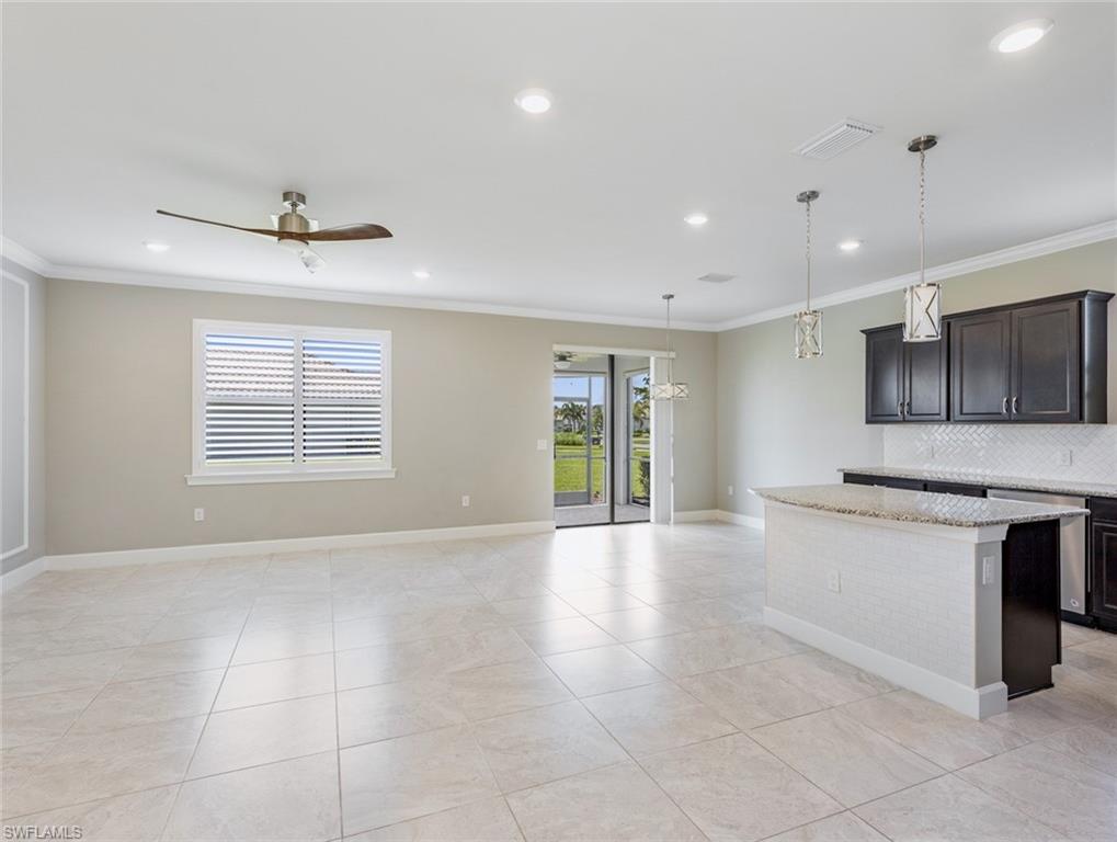 19953 Beverly Park Road Estero, FL 33928 - Photo 3 of 35 a view of an empty room with kitchen and window