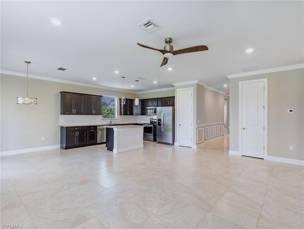 19953 Beverly Park Road Estero, FL 33928 - Photo 4 of 35 a large white room with stainless steel appliances kitchen view and living room view