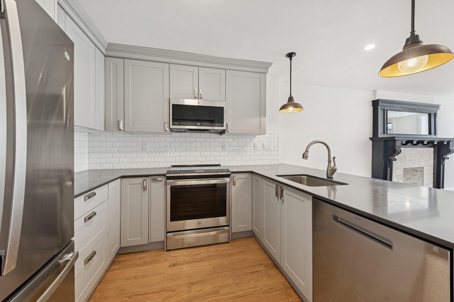 282 Convent Avenue, Unit 1 Manhattan, NY 10031 - Photo 5 of 14 a kitchen with stainless steel appliances granite countertop a sink stove and microwave
