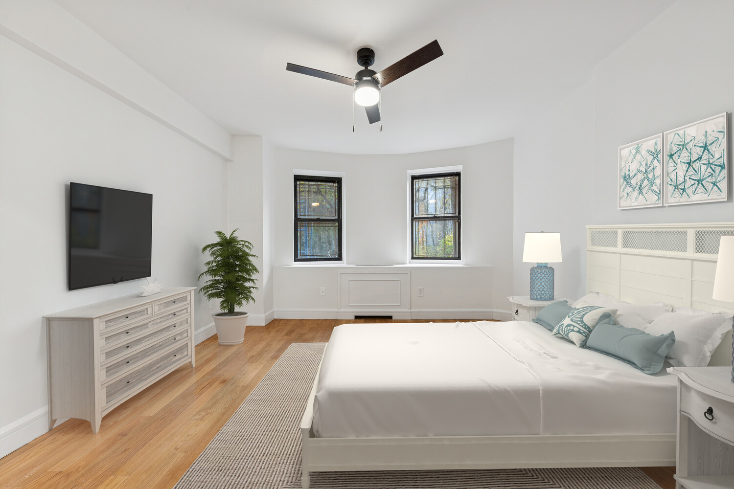 282 Convent Avenue, Unit 1 Manhattan, NY 10031 - Photo 6 of 14 a spacious bedroom with a large bed and a flat screen tv