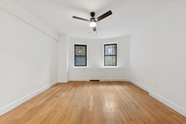a spacious bedroom with a large bed and a flat screen tv