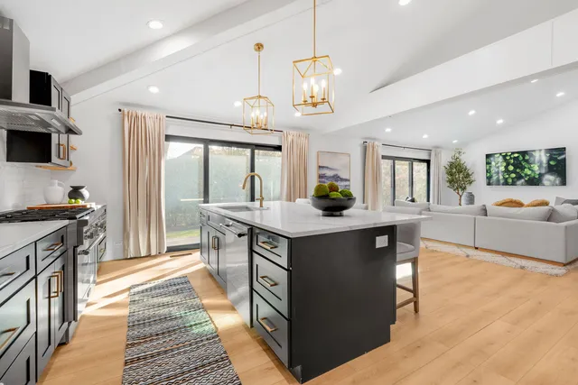 a kitchen with stainless steel appliances a sink and a stove