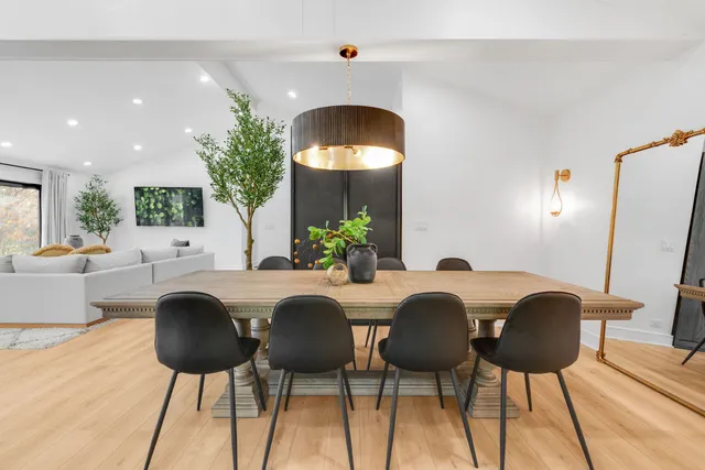 a dining room with furniture and wooden floor