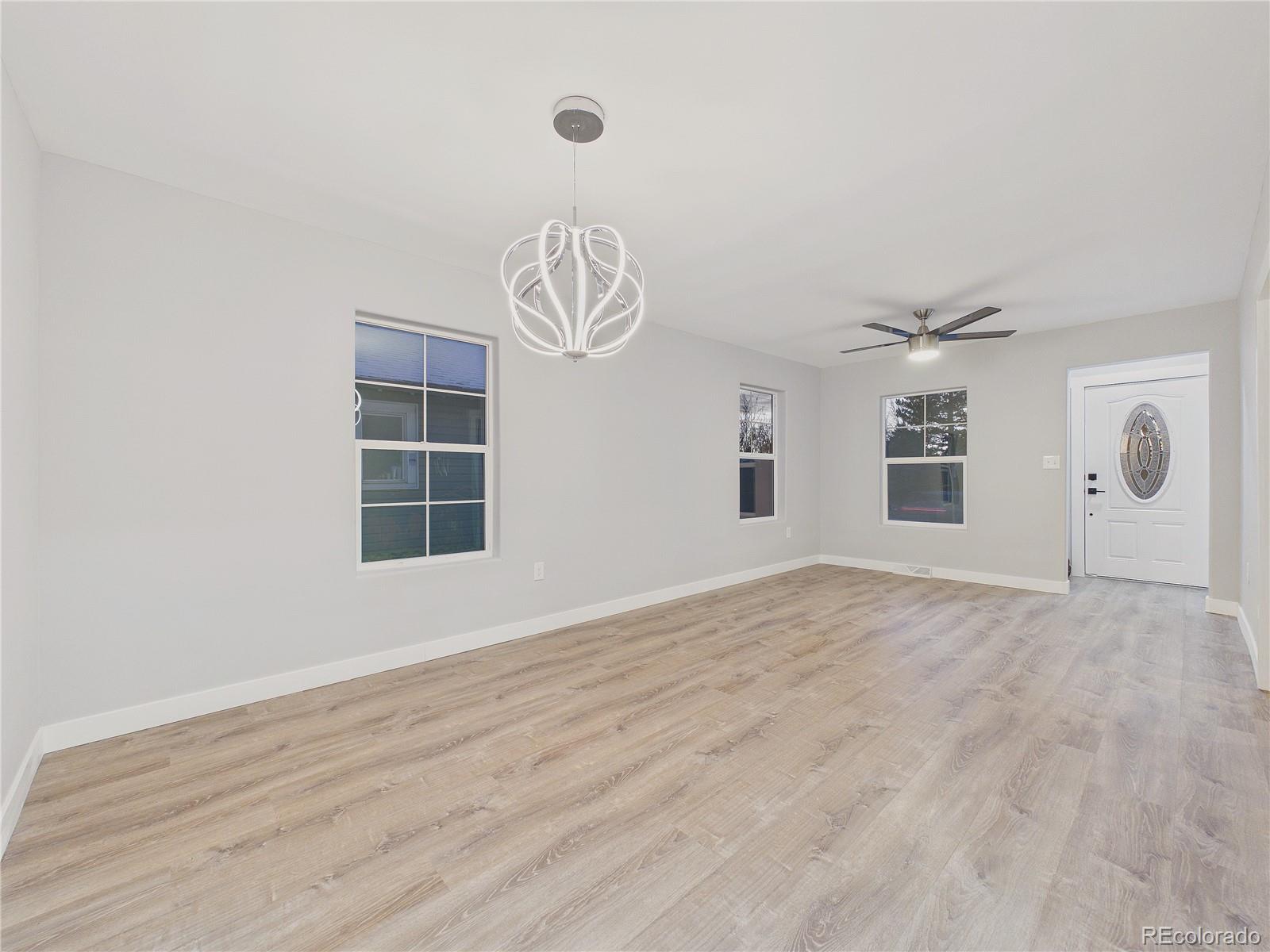 1784 South Downing Street Denver, CO 80210 - Photo 11 of 29 a view of empty room with wooden floor and fan