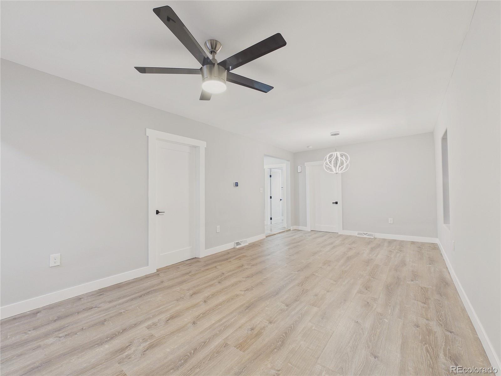 1784 South Downing Street Denver, CO 80210 - Photo 14 of 29 an empty room with wooden floor and windows
