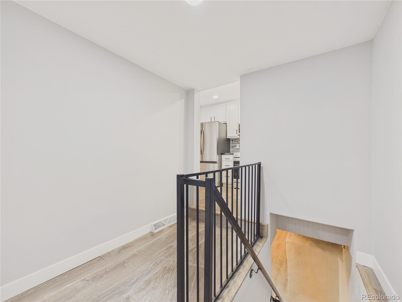1784 South Downing Street Denver, CO 80210 - Photo 23 of 29 a view of hallway with wooden floor
