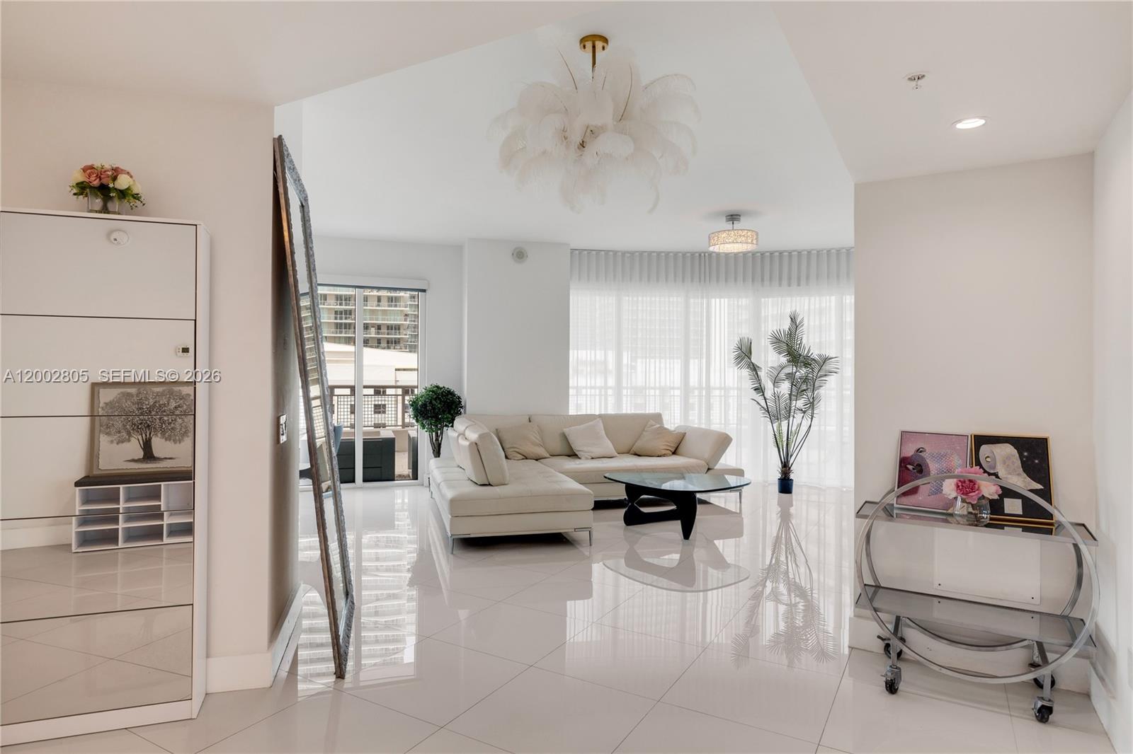 60 Southwest 13th Street, Unit 1124 Miami, FL 33130 - Photo 3 of 30 a living room with furniture and a chandelier