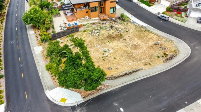 a view of a house with a snow on the road and covered with trees