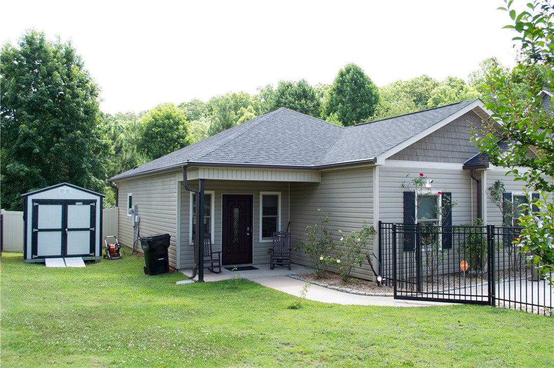 3 Cringle Lane Anderson, SC 29625 - Photo 25 of 26 A well-maintained facade features a covered entry, tidy landscaping, and a secure fenced yard.