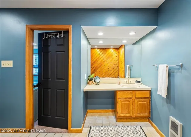 a bathroom with a sink a toilet and mirror