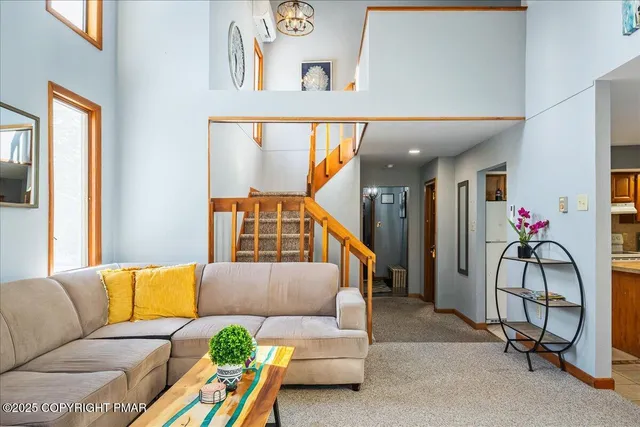 a living room with furniture and a potted plant