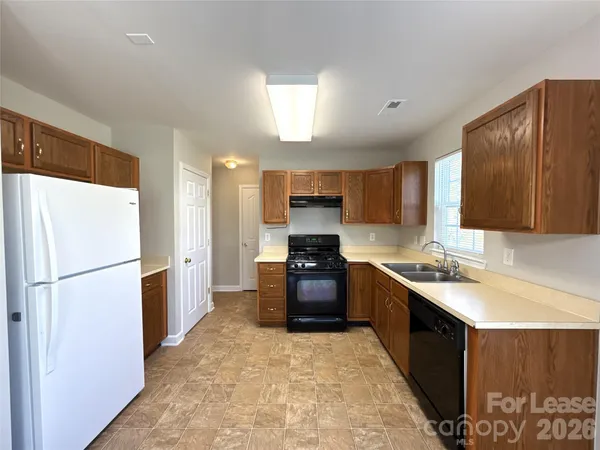 a kitchen with a sink stove and refrigerator