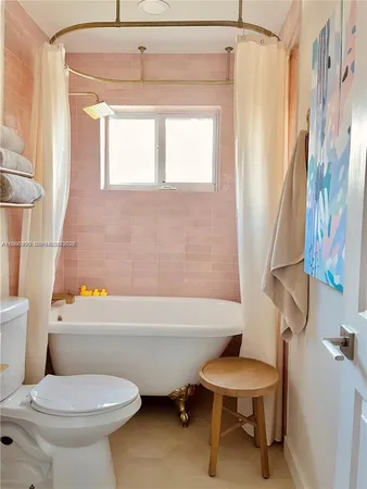 a bathroom with a toilet a sink and a bathtub
