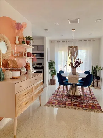 a kitchen with stainless steel appliances kitchen island granite countertop a table and chairs in it