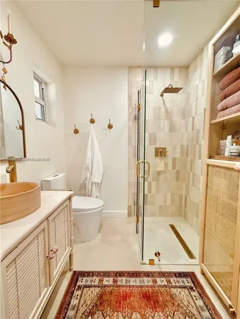 a bathroom with a sink a toilet and shower