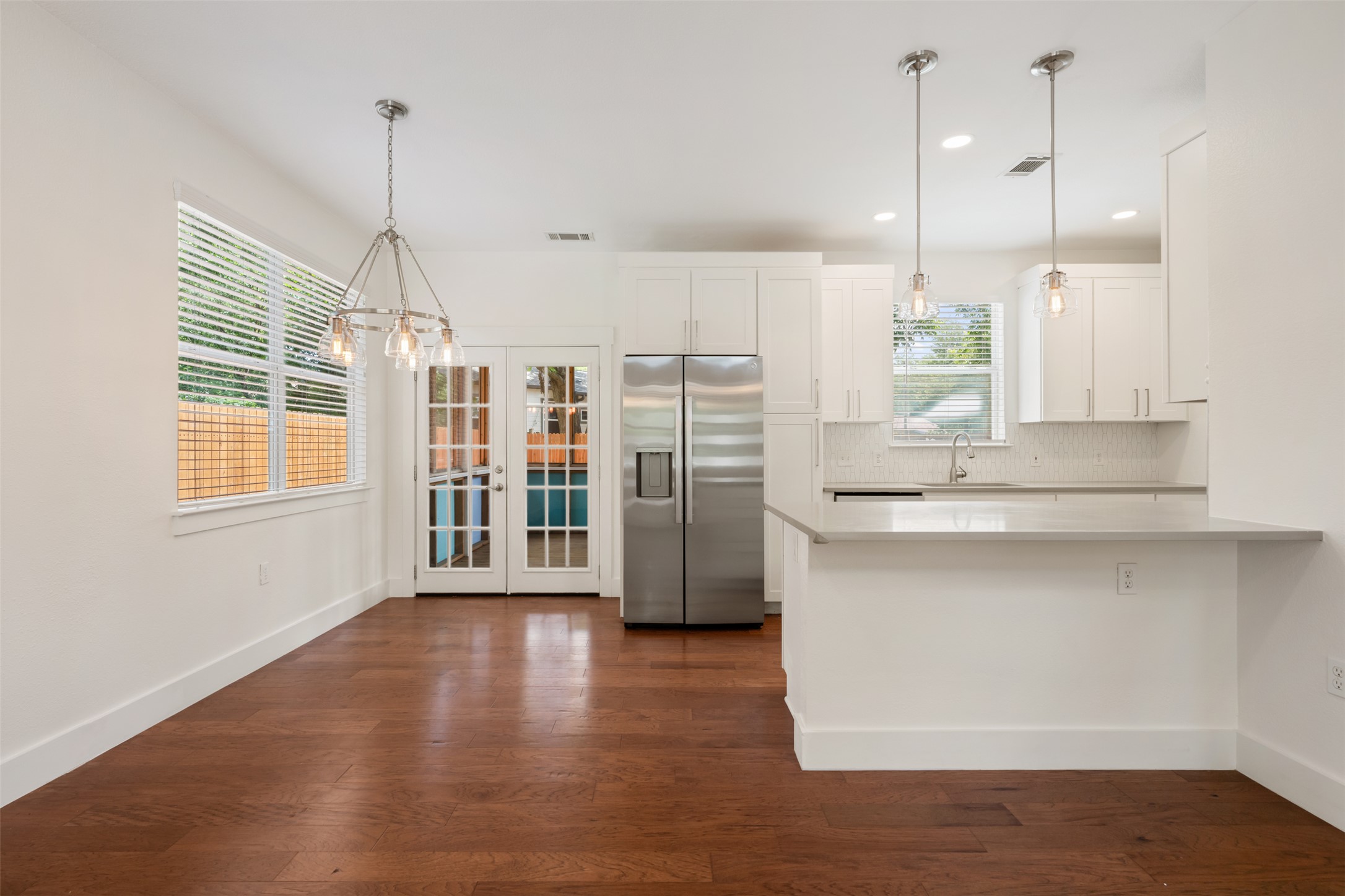 4912 Sara Drive, Unit A Austin, TX 78721 - Photo 9 of 28 Dining area with French doors leading to the screened in porch.