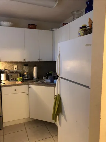 a white refrigerator freezer sitting in a kitchen