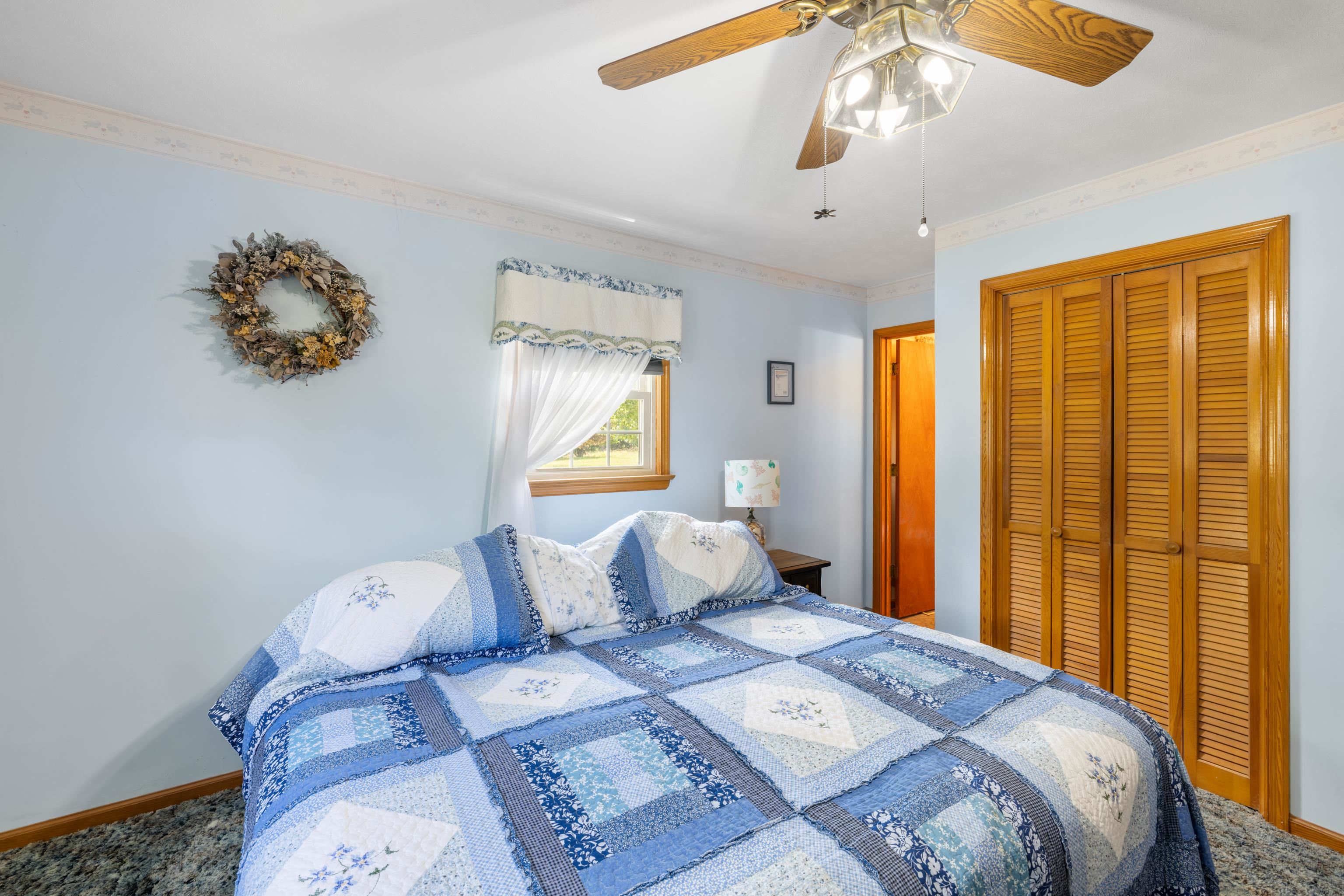 500 Varner Road Churchville, VA 24421 - Photo 31 of 64 a bedroom with a bed and a chandelier