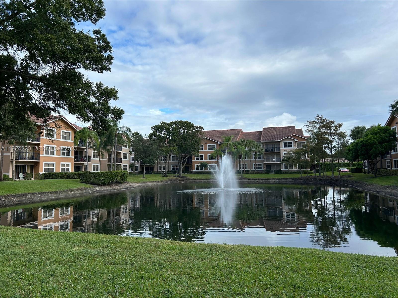 8977 Wiles Road, Unit 208 Coral Springs, FL 33067 - Photo 27 of 28 a lake view with a garden space