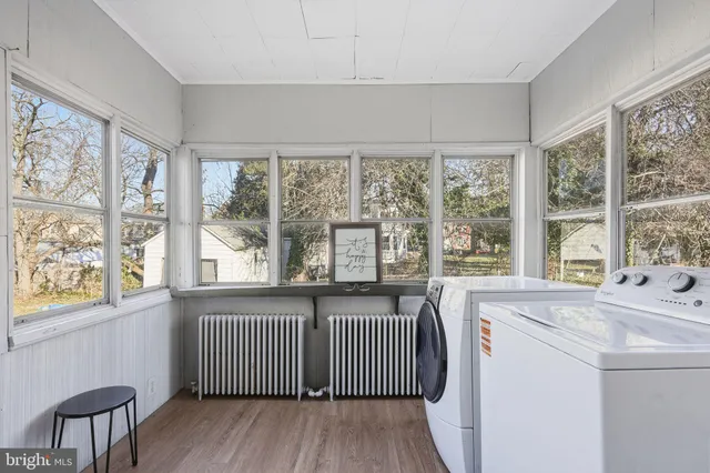 a view of a room with a window and wooden floor