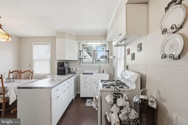a kitchen with a sink appliances and cabinets