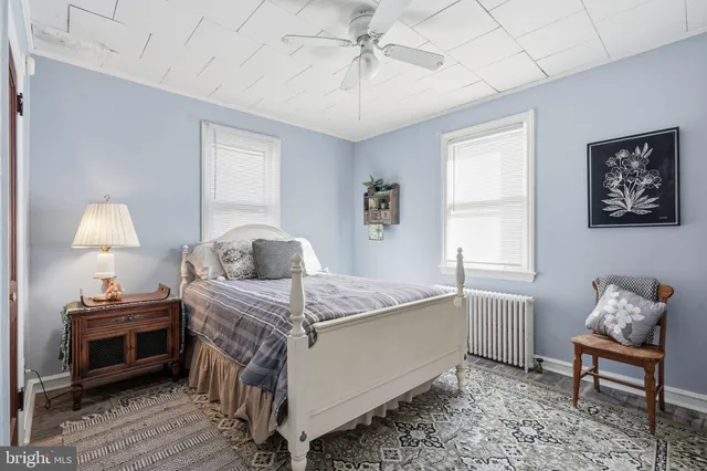 a bedroom with a bed table and a window