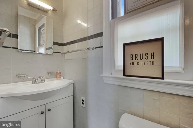 a bathroom with a sink a mirror and a toilet