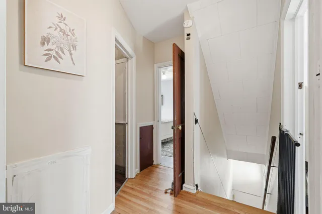 a view of a hallway with wooden floor and entryway
